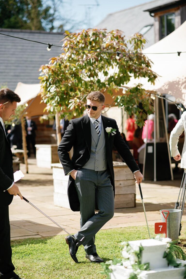 Guests playing wedding mini golf during an outdoor reception