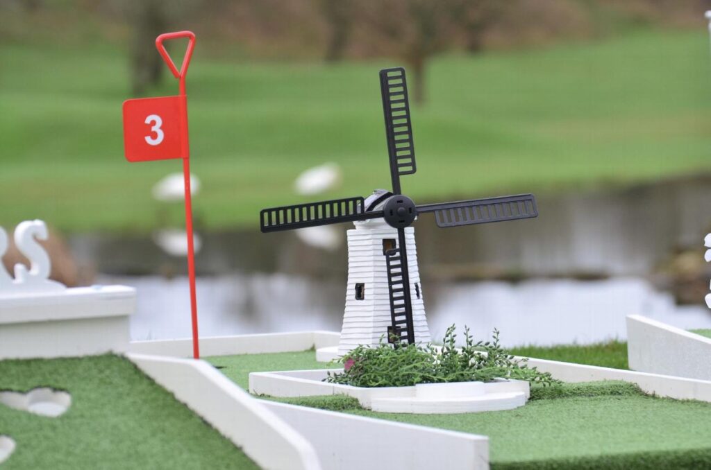 Wedding mini golf hole with windmill obstacle